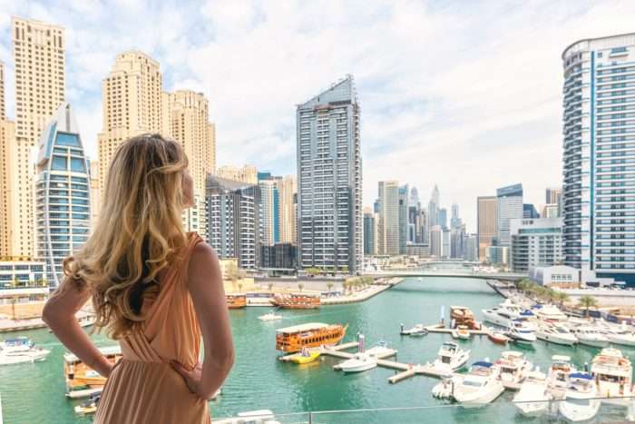 Woman overlooking Dubai Marina - representing British expats living abroad who use PrintPigeon